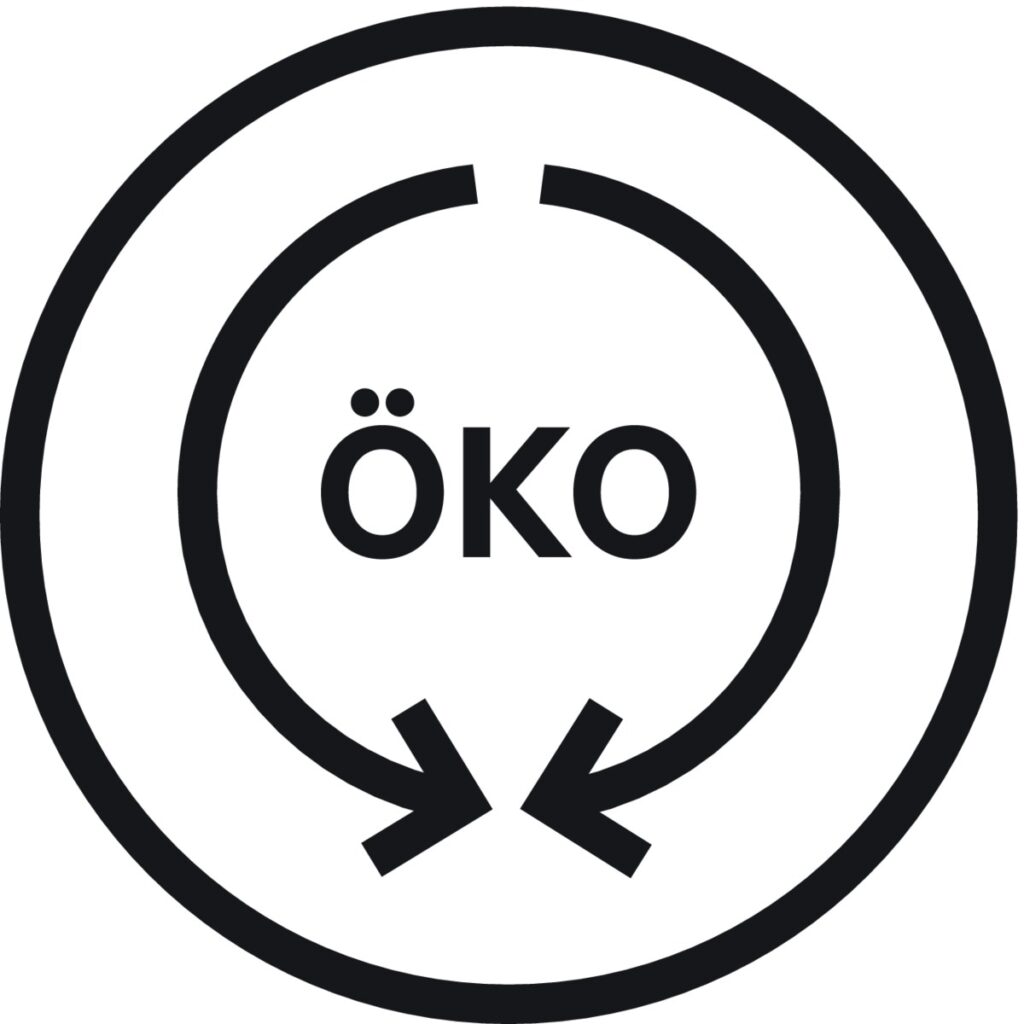 Symbole circulaire « ÖKO » avec des pointes de flèche pointant vers l'intérieur, souvent vu sur la machine à laver AEG LTR7C7130D pour indiquer le respect de l'environnement ou la durabilité environnementale.