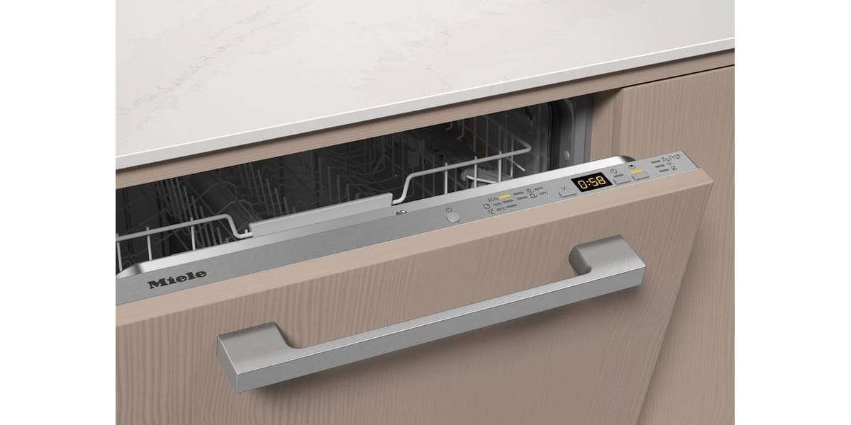 Le lave-vaisselle MIELE G 5150 VI s'intègre parfaitement au meuble de cuisine en bois et son écran affiche 58 minutes restantes.