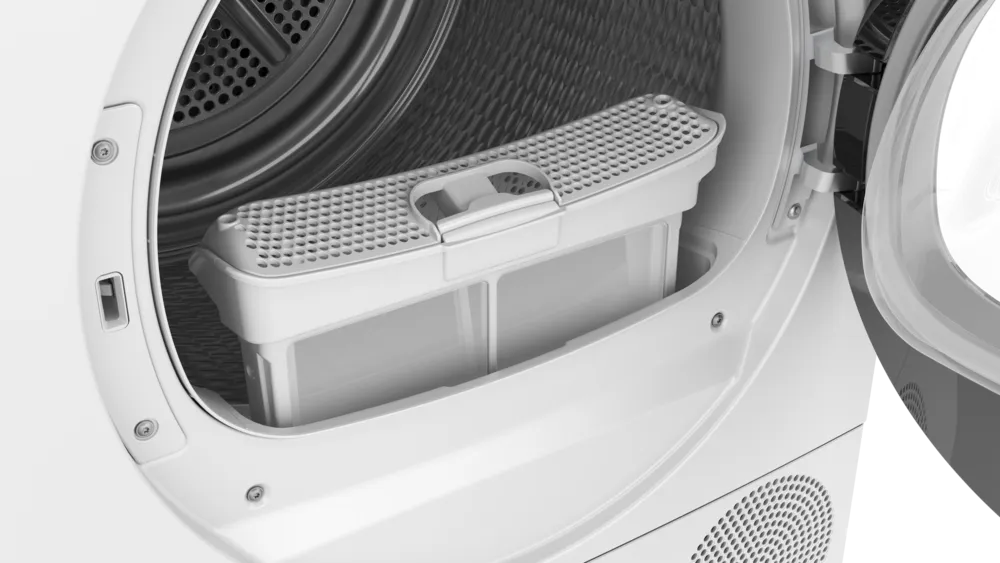 Gros plan de la porte ouverte du sèche-linge SIEMENS WQ46H2CAFR, montrant le filtre à peluches situé à l'intérieur du tambour.
