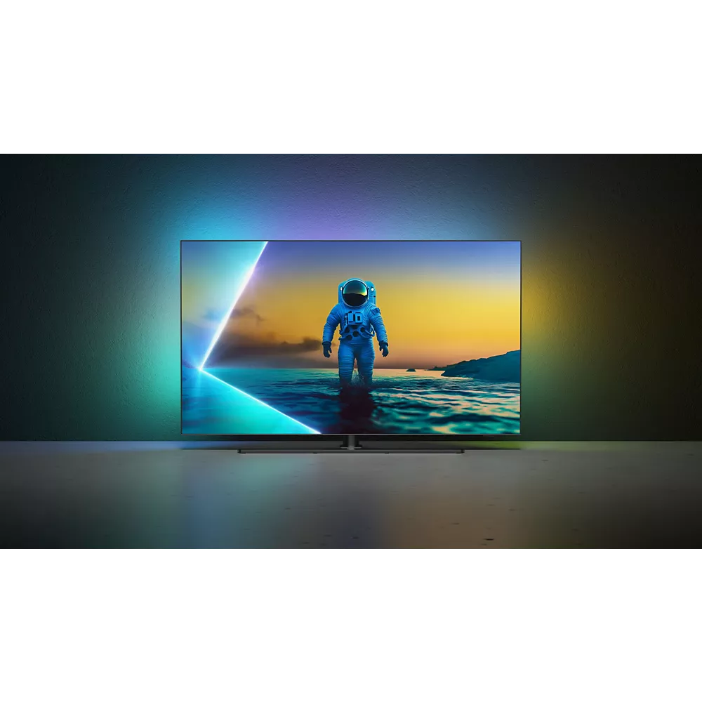 Un téléviseur PHILIPS 55OLED850/12 OLED affiche un astronaute debout dans l'eau, éclairé par des lumières colorées vibrantes derrière l'écran.