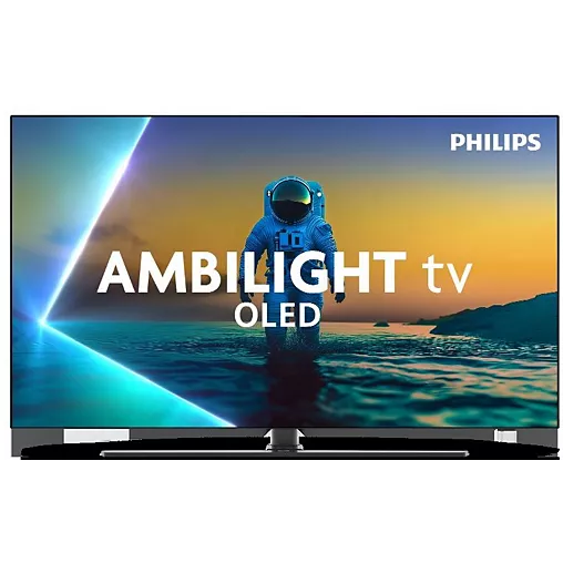 Le téléviseur PHILIPS 65OLED850/12 OLED affiche un astronaute debout dans une eau peu profonde au coucher du soleil, avec des couleurs vibrantes et des détails impressionnants.