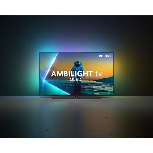Un téléviseur PHILIPS 65OLED850/12 OLED met en scène un astronaute avec des effets Ambilight vibrants qui illuminent le mur derrière lui.