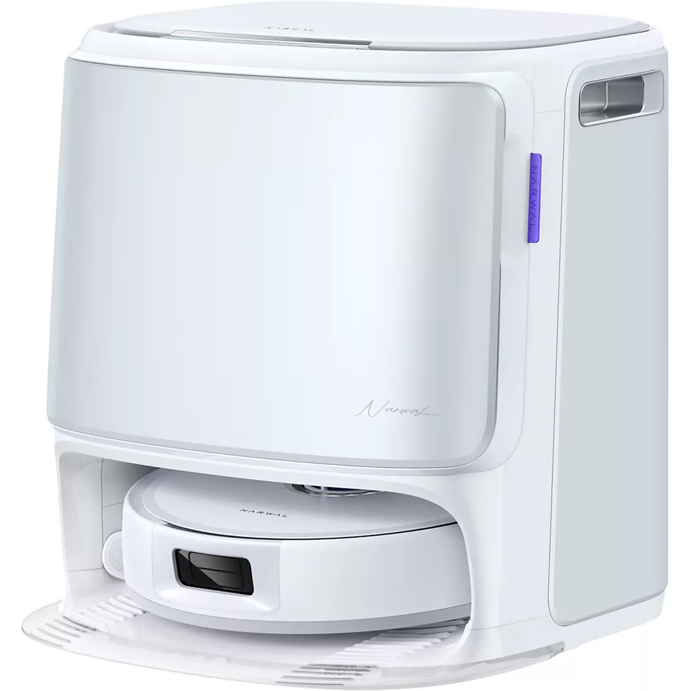 L'aspirateur robot NARWAL FREO FLOW est installé dans sa station de charge et de nettoyage assortie.
