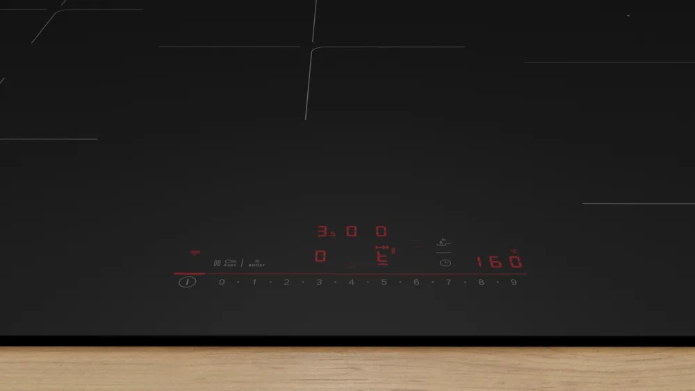 La table de cuisson à induction BOSCH PVW89BHC1E en verre noir est dotée de commandes numériques rouges et s'harmonise avec tous les comptoirs en bois.