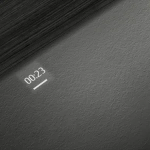 Le compte à rebours minimaliste SIEMENS SN65Z804CE affiche 00:23 sur une surface gris foncé texturée, mise en valeur par un éclairage diagonal.