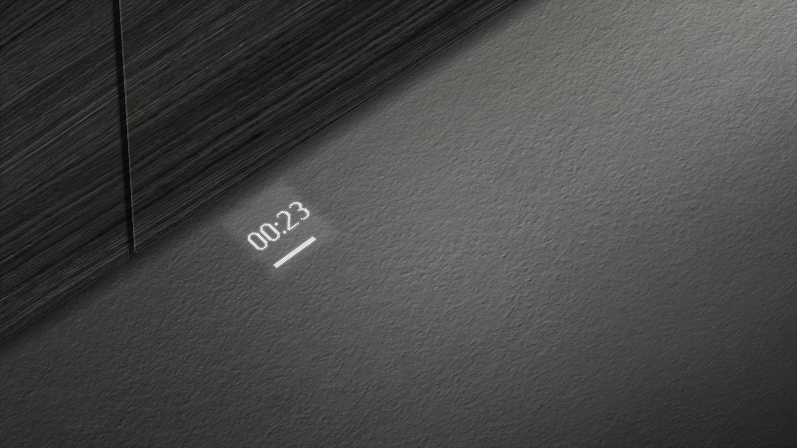 Le compte à rebours minimaliste SIEMENS SN65Z804CE affiche 00:23 sur une surface gris foncé texturée, mise en valeur par un éclairage diagonal.