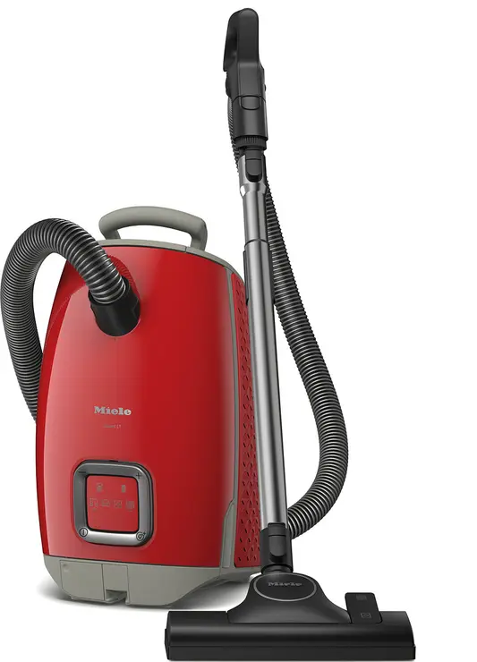 Le Miele GUARD L1 RED PULSE est un aspirateur-traîneau rouge avec un tuyau noir et un accessoire pour le sol. Il se tient debout et est doté de la technologie GUARD L1.