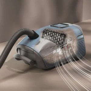 L'aspirateur Miele GUARD L1 RED PULSE montre le flux d'air RED PULSE et la poussière filtrée à l'intérieur de son corps transparent pendant l'utilisation.