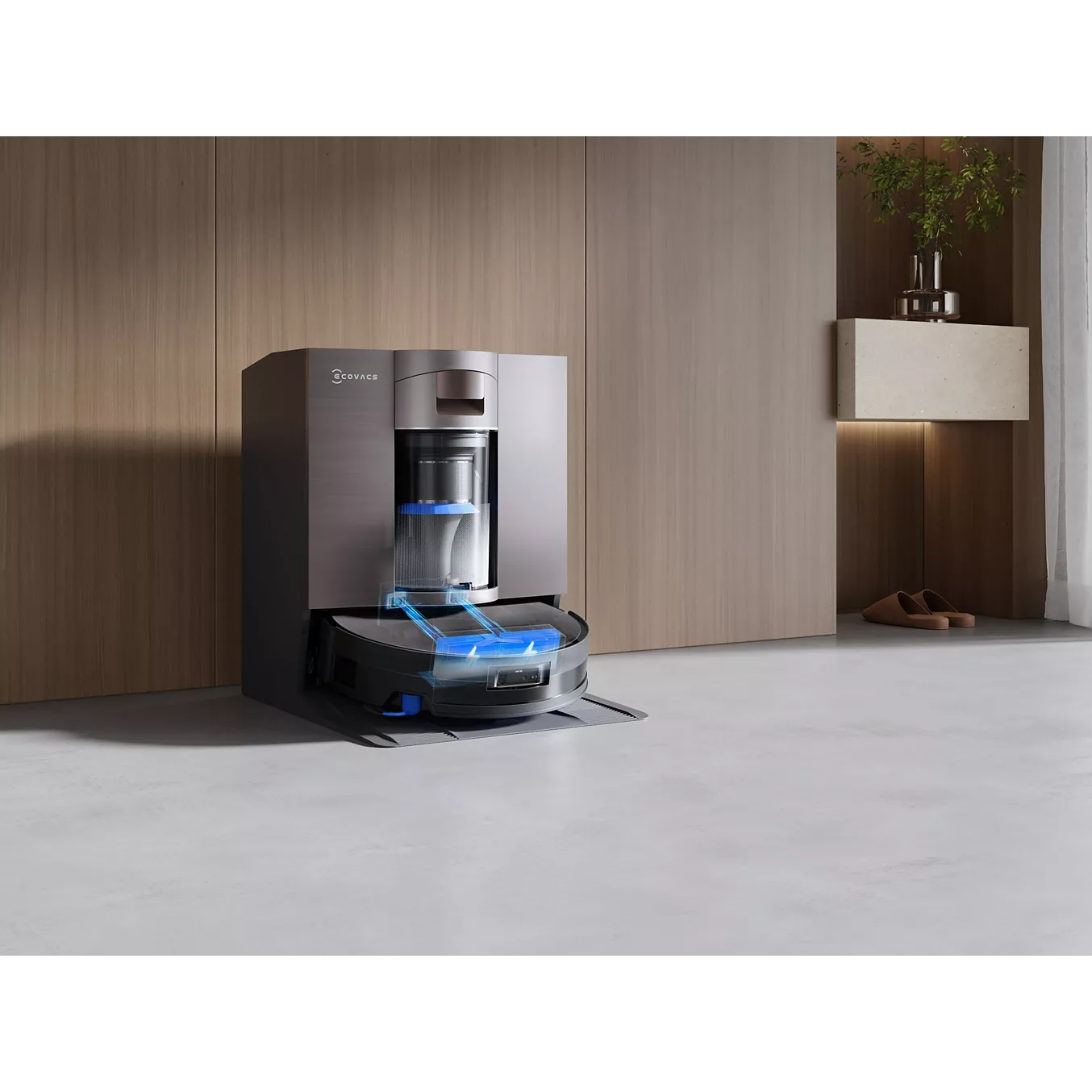 L'aspirateur robot ECOVACS X11 omni est installé dans sa station de charge élégante, près d'un mur en bois moderne, apportant une touche d'élégance à l'espace minimaliste.