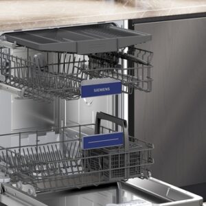 Un lave-vaisselle SIEMENS SN63E800VE avec des grilles étendues se trouve ouvert sous un comptoir en marbre dans une cuisine moderne.