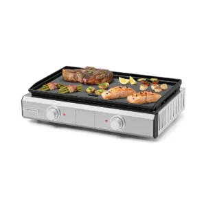 Vue de face du grill électrique RIVIERA & BAR QPL1060, sur lequel cuisent un steak, du saumon, des légumes et des tranches de citron.