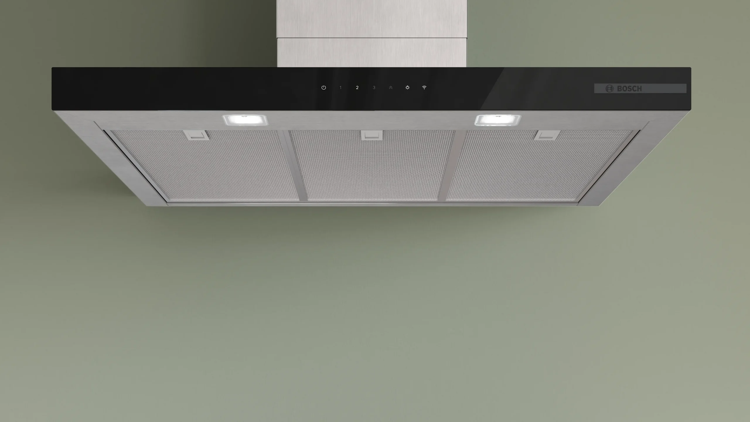 Hotte aspirante moderne DWB97DN en acier inoxydable et noir, équipée de trois filtres et d'un éclairage intégré, fixée contre un mur vert.