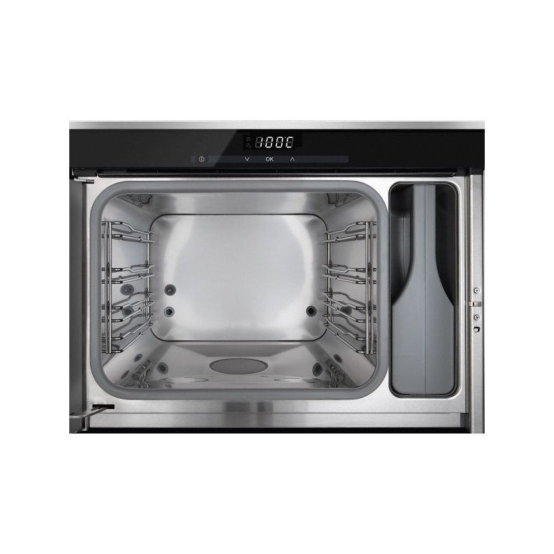 Le four MIELE DG6019NR est doté d'un intérieur ouvert en acier inoxydable, d'un panneau de commande situé sur le dessus et d'une enceinte de cuisson vide.