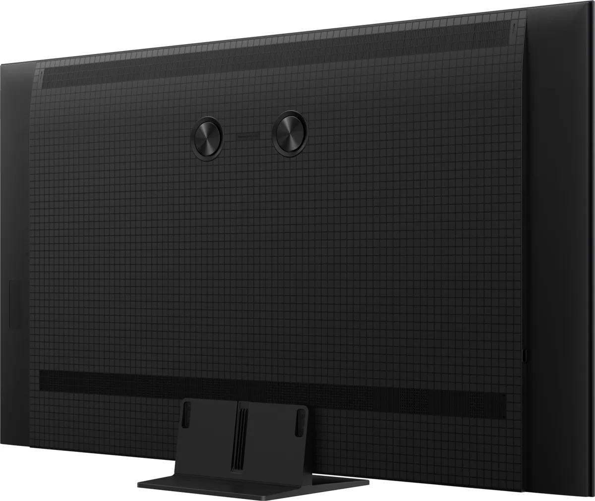 Vue arrière du téléviseur à écran plat TCL 65C6K PRO posé sur son socle, présentant un motif en grille et deux fixations circulaires.